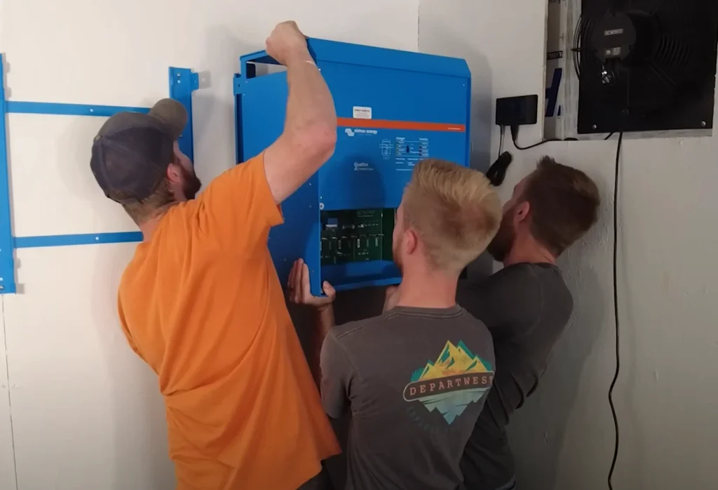 Two Victron Quattro 10kVA inverters. 20kW continuous, 40kW surge. Enough to start a plasma table and a compressor without blinking.