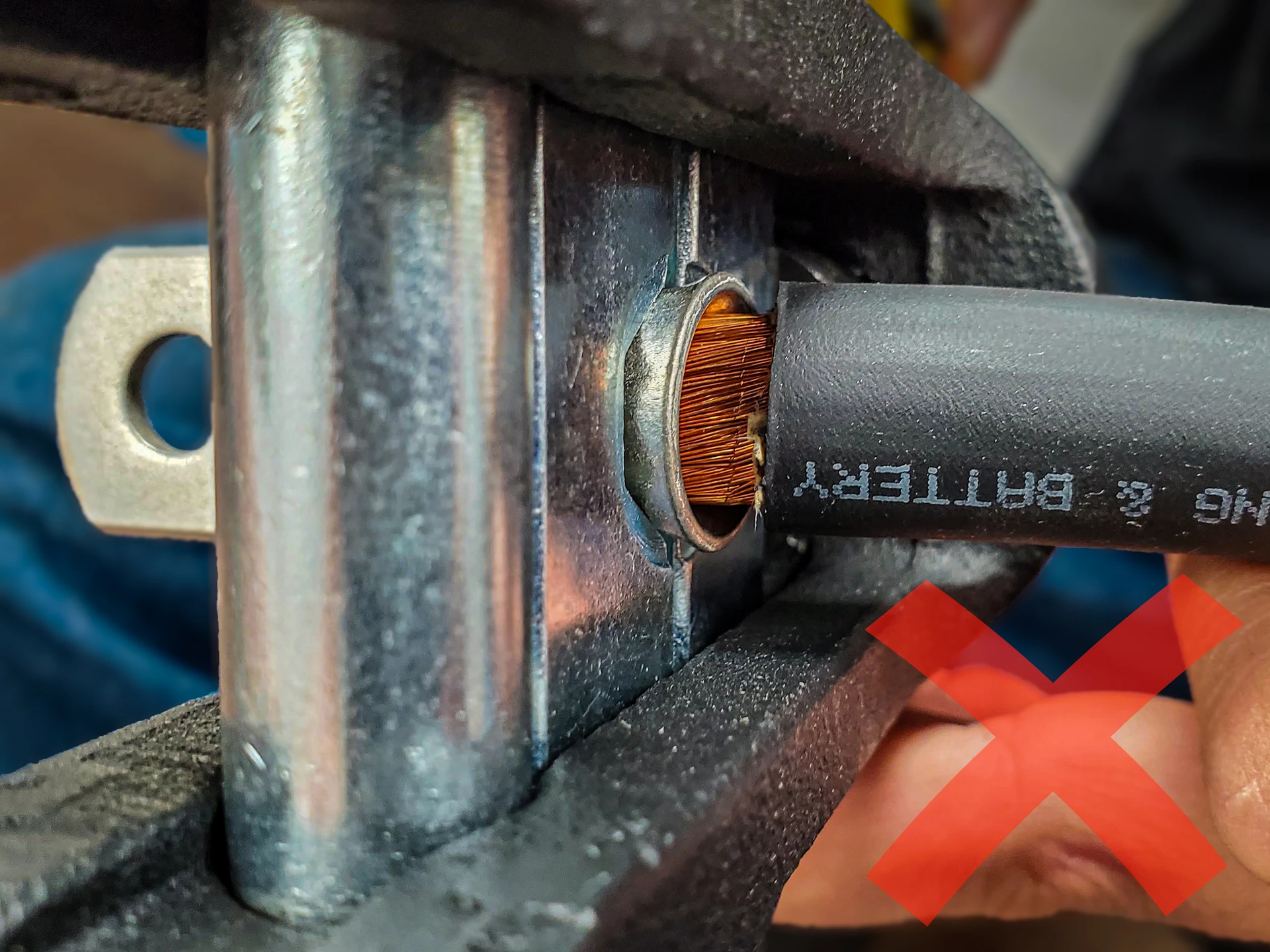 Photo of the wire with the lug, but copper wire shows between the lug and the cable insulation. 