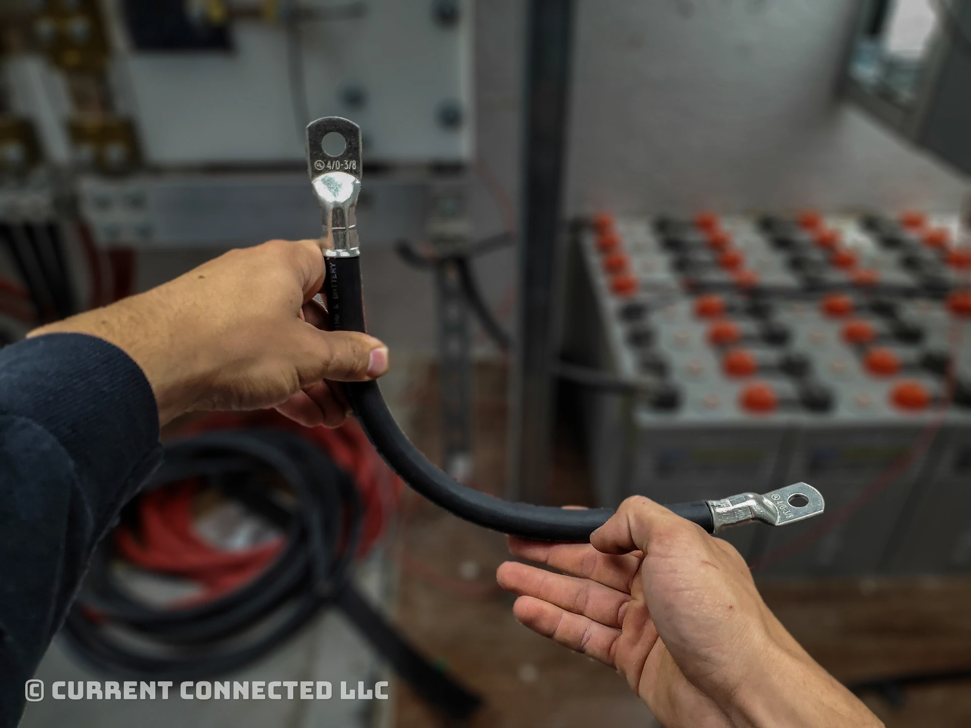 Photo of someone holding the wire to show the lugs on both ends. 